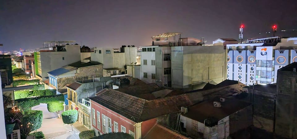 Nighttime city view from private balcony