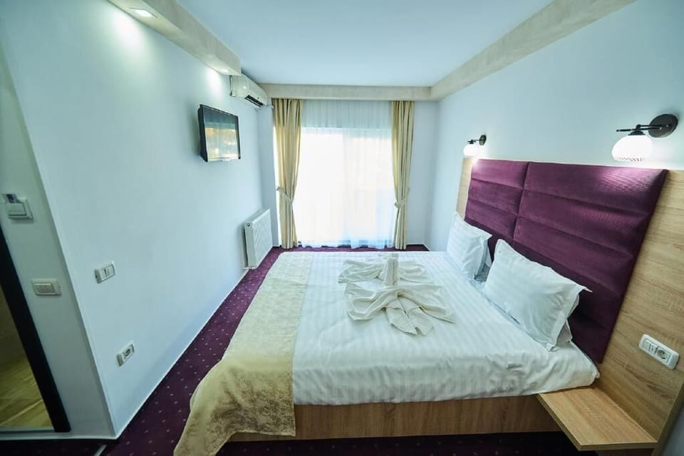 Comfort Room | Desk, iron/ironing board, bed sheets