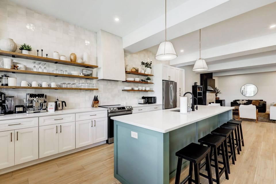 Bar seating at large kitchen island, kitchen is fully stocked for cooking 