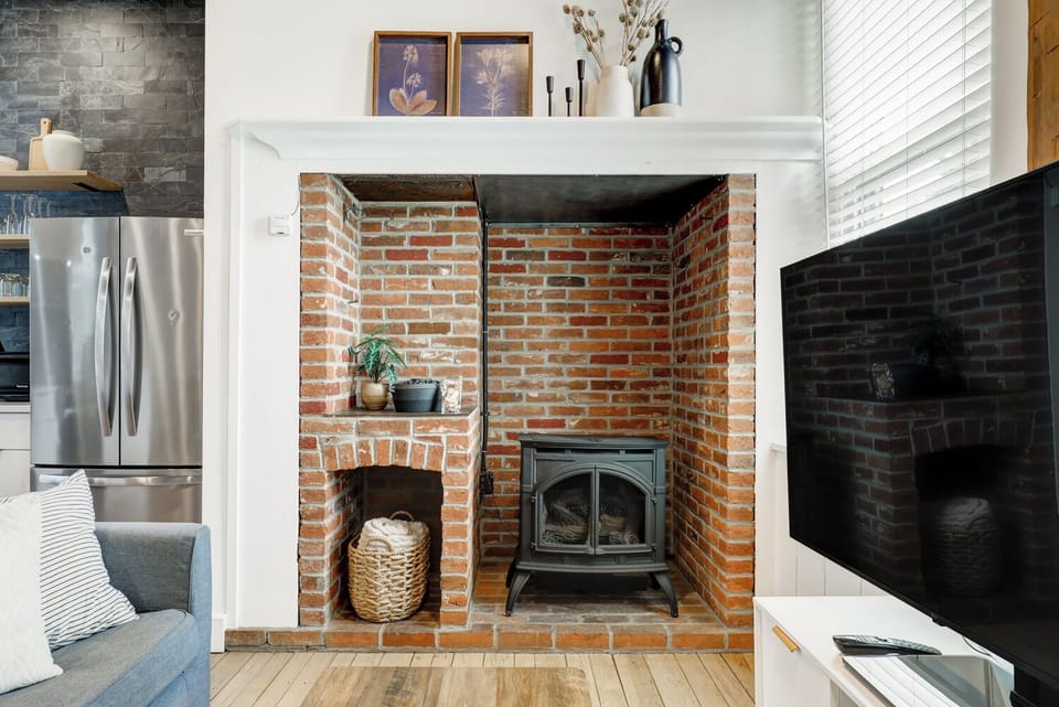 Inglenook fireplace with propane fueled cast iron stove for cozy heat