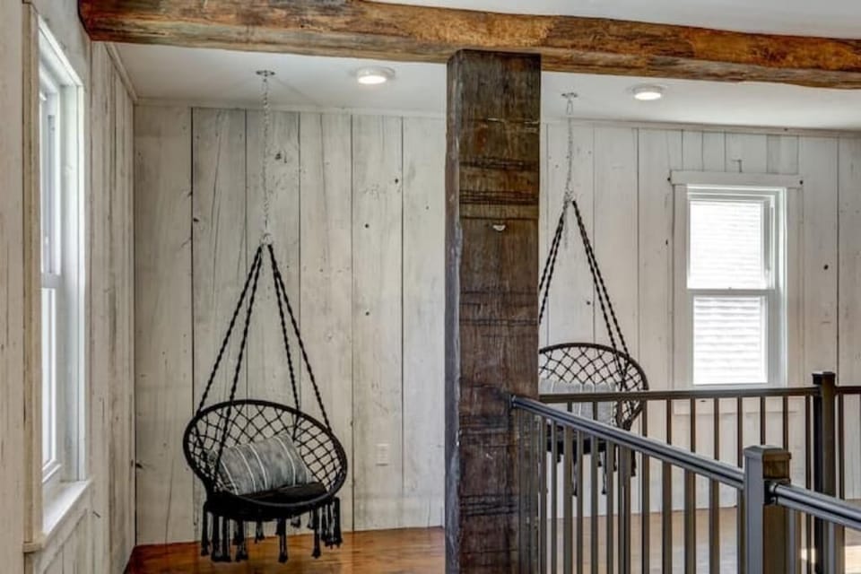 Hanging chairs on second floor walkway in The Barn 