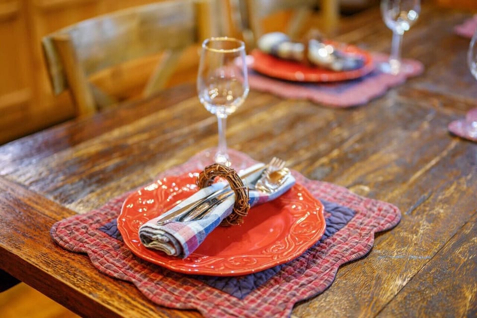 Where meals become memories in the rustic embrace of the cabin`s dining table.