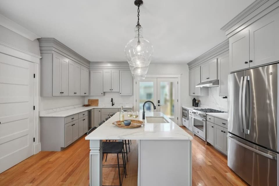 Kitchen | Large Kitchen with Marble Island and Bar Seating | First Floor