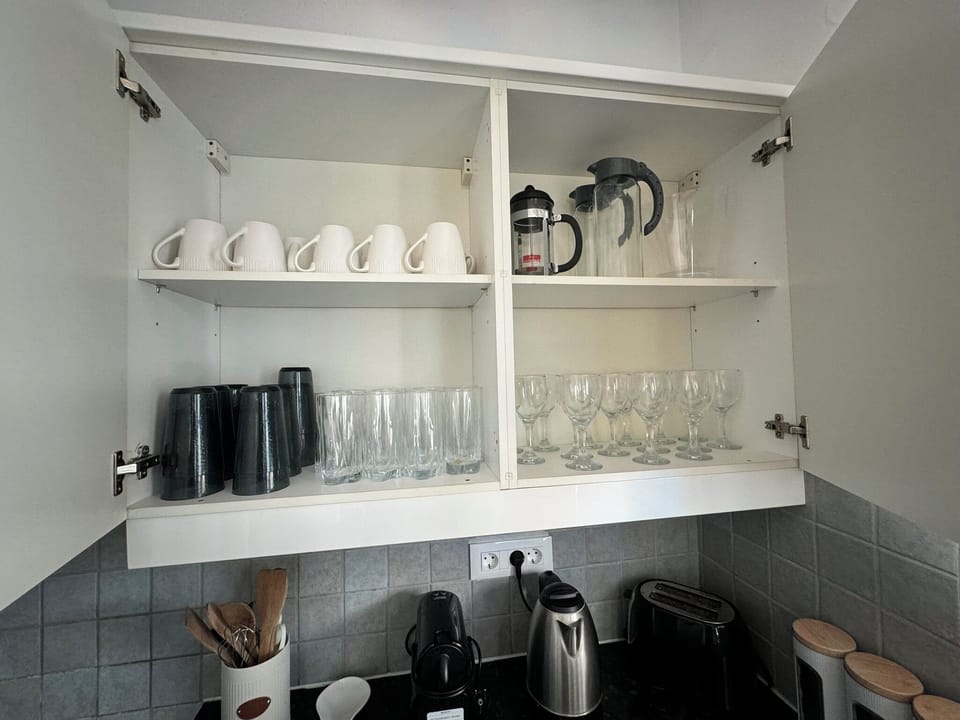 Kitchen is stocked with all the cups, pots pans needed to make an amazing meal!