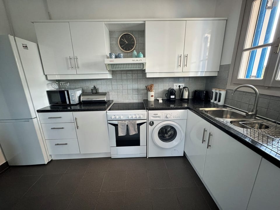 Includes refrigerator, microwave, Nespresso coffee maker, tea pot, utensils