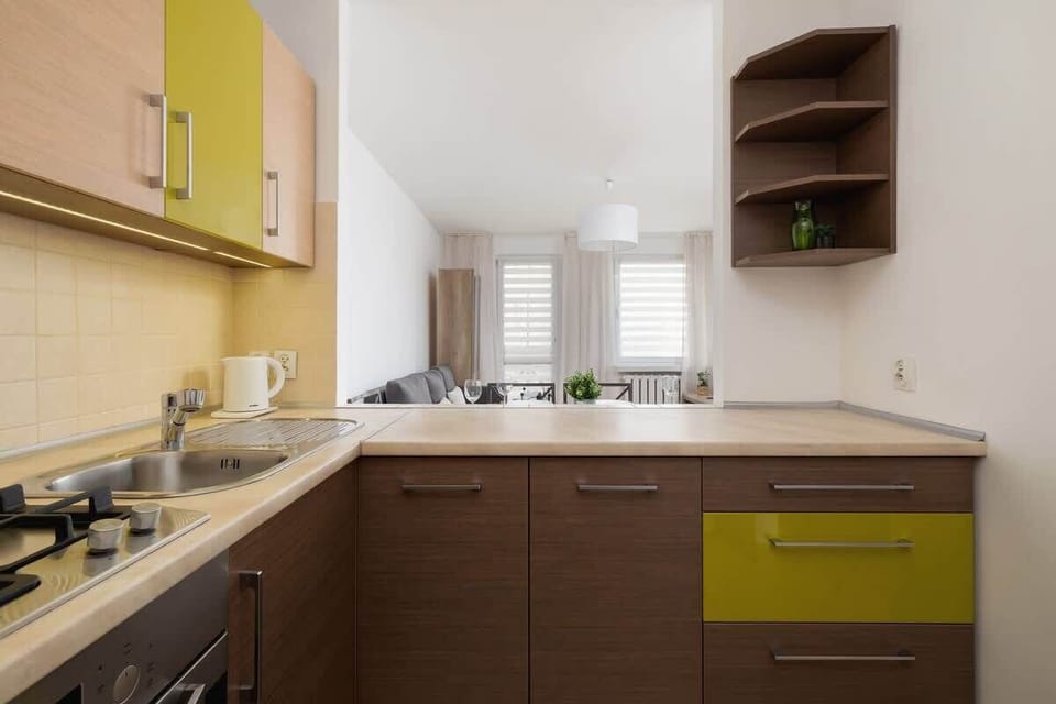 A wider view of the kitchen, highlighting its natural light, wooden accents, and well-organized space, offering a balance of aesthetics and functionality.







