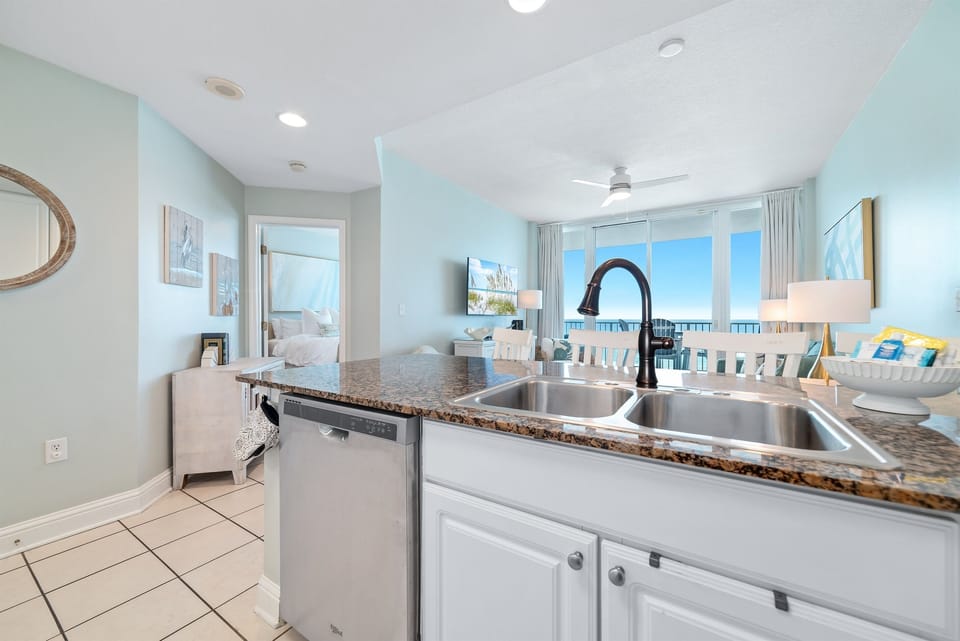 Fully-equipped kitchen featuring high-end appliances and inspiring sea vistas seamlessly flow between the living and dining areas.