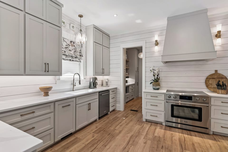 Your gourmet kitchen awaits with sleek gray cabinets, marble counters, and professional-grade appliances for creating memorable meals.