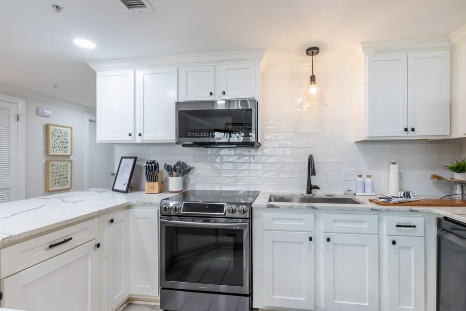 Prepare meals in this elegant kitchen with modern stainless appliances, elegant fixtures, and a stylish design
