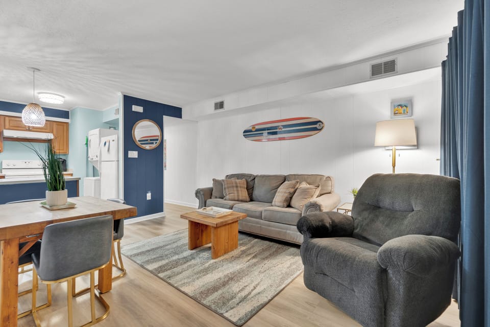 Living Room with a Queen sized sleep sofa, recliner, & Dining for four.