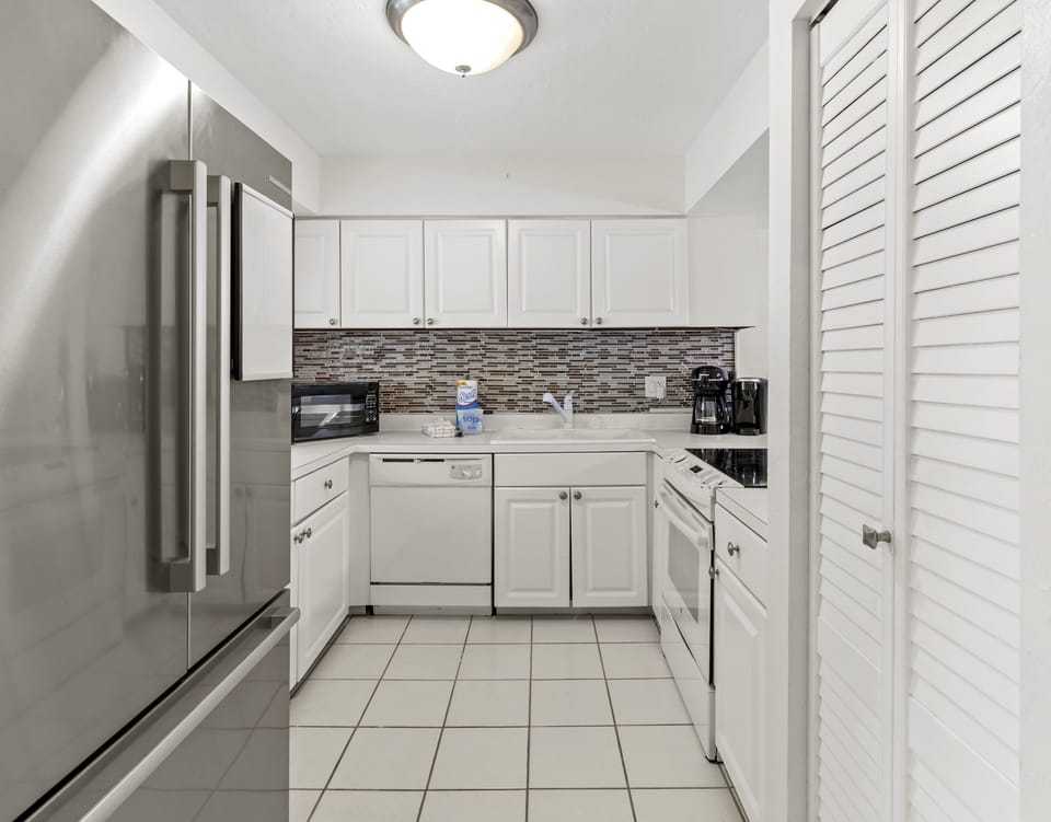 Modern Kitchen With Dishwasher, Stove, Microwave & Ample Cabinet Space