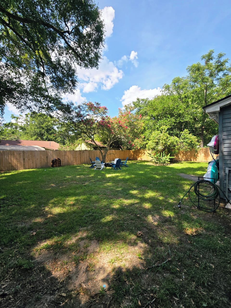 Backyard with seating, firepit & firewood available for guests