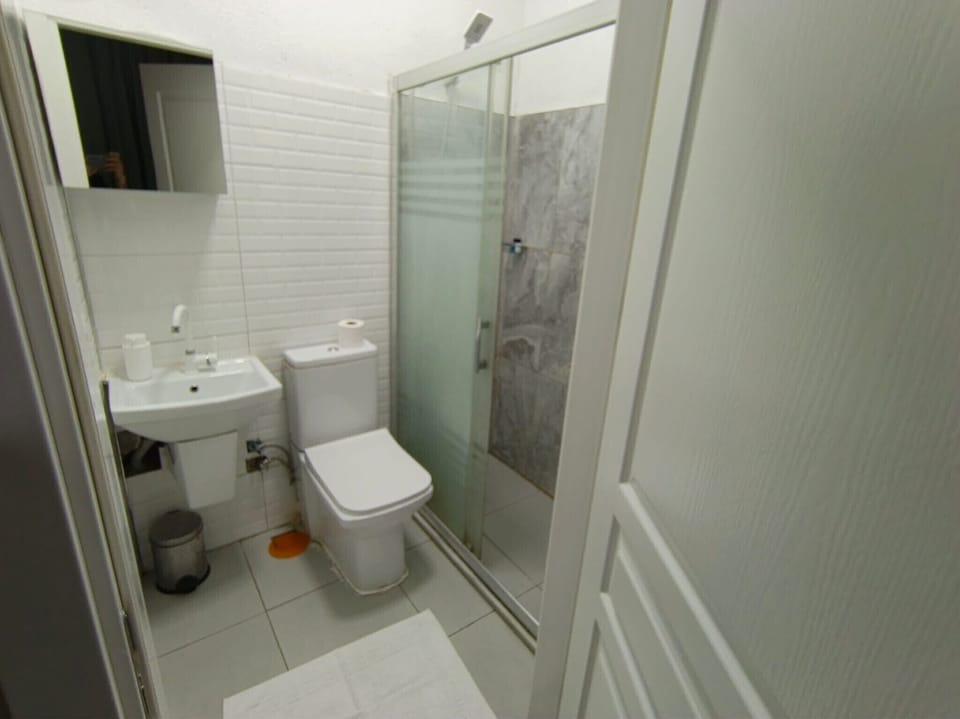 Shower, hair dryer, slippers, towels