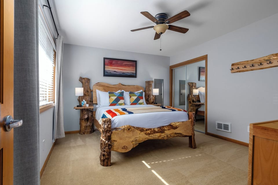Main bedroom has a queen bed, black-out curtains, reading lights with charging