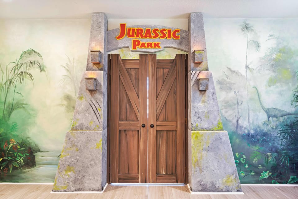 - Jurassic Park themed game room entrance with immersive décor  
- Custom murals and creative design bring adventure to life  
- Orlando family vacation rental with themed entertainment
