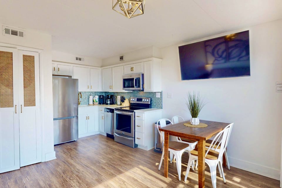 You'll find an in unit washer + dryer tucked behind the custom doors