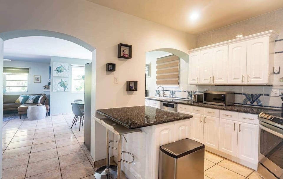 Fully-equipped kitchen boasting ample storage space and generous countertops for convenient food preparation.