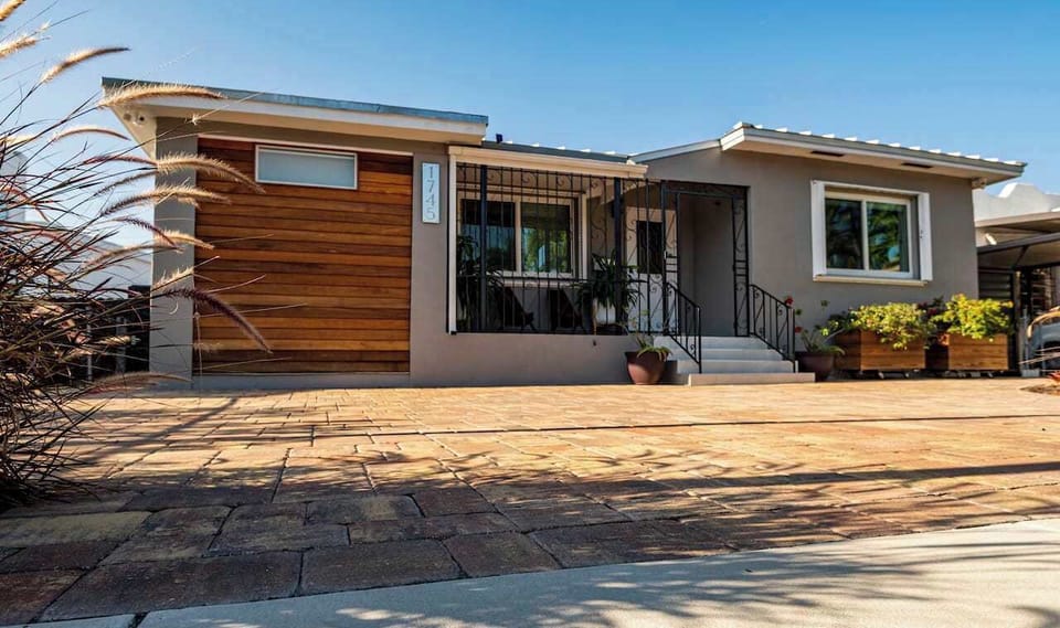 Chic and roomy front porch complemented by a convenient parking space.