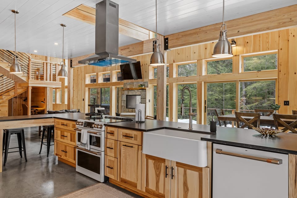 The kitchen features brand new appliances including an induction stove top with two separate ovens, a dishwasher, refrigerator and freezer, etc.