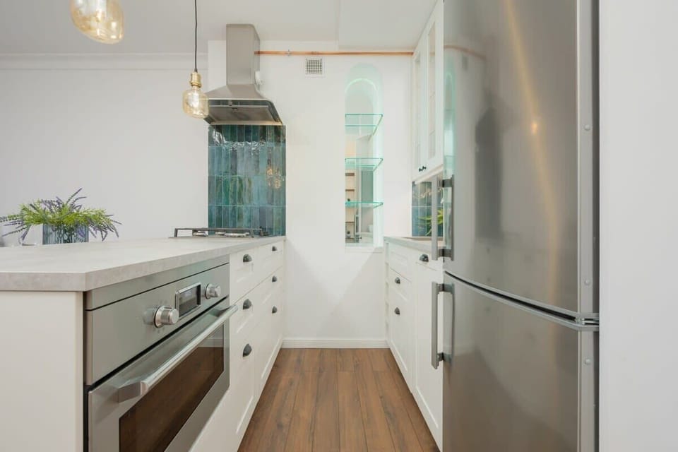 Fully equipped kitchenette with gas cooktop, electric kettle, refrigerator with freezer, dishwasher, oven with microwave option, set of dishes, kitchen utensils and dining area