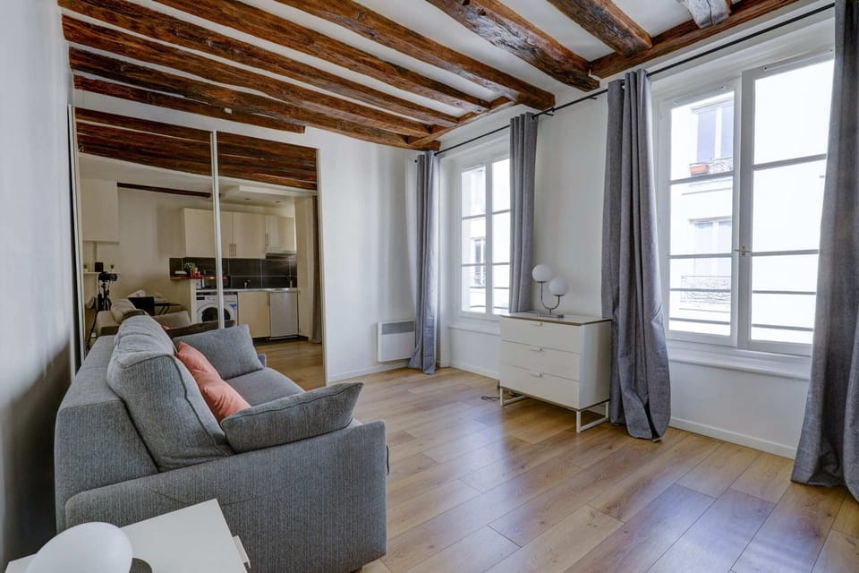 The living area is furnished with a sofa bed.