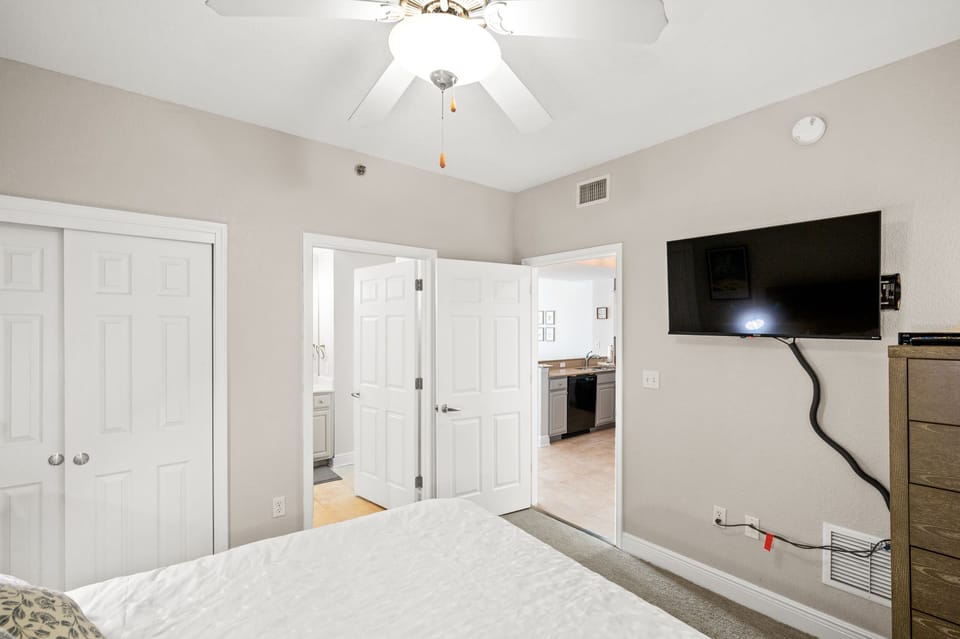 2nd bedroom that offers a queen bed, 2 nightstands, chest of drawers, a 42" wall mounted SMART TV, double closet and a private entrance into the main bathroom