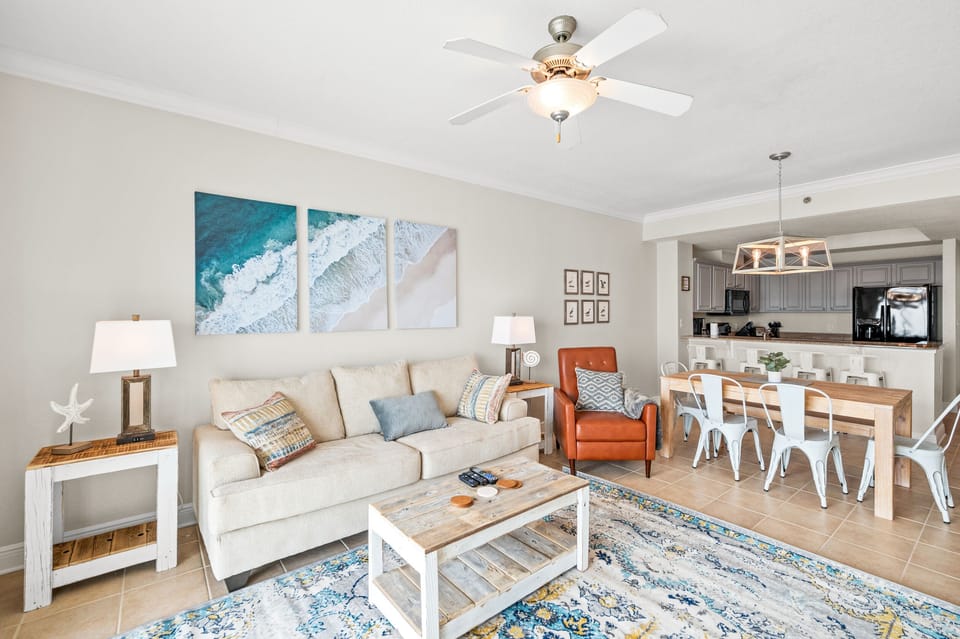 Living room that offers a breathtaking Gulf view, sleeper sofa, 1 recliner, 1 arm chair and a 55" wall mounted SMART TV