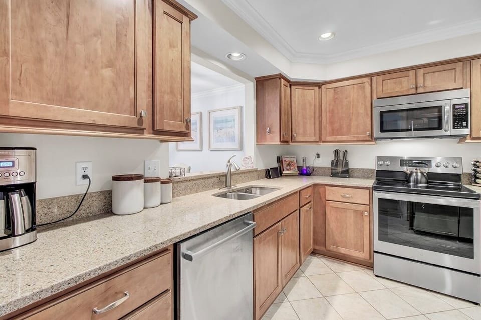 - Bright, well stocked kitchen ready for anything from pancake breakfasts to seafood dinners - Sleek appliances, granite counters, & open shelving make cooking feel effortless - Stay part of the conversation thanks to the open layout & peek through pass
