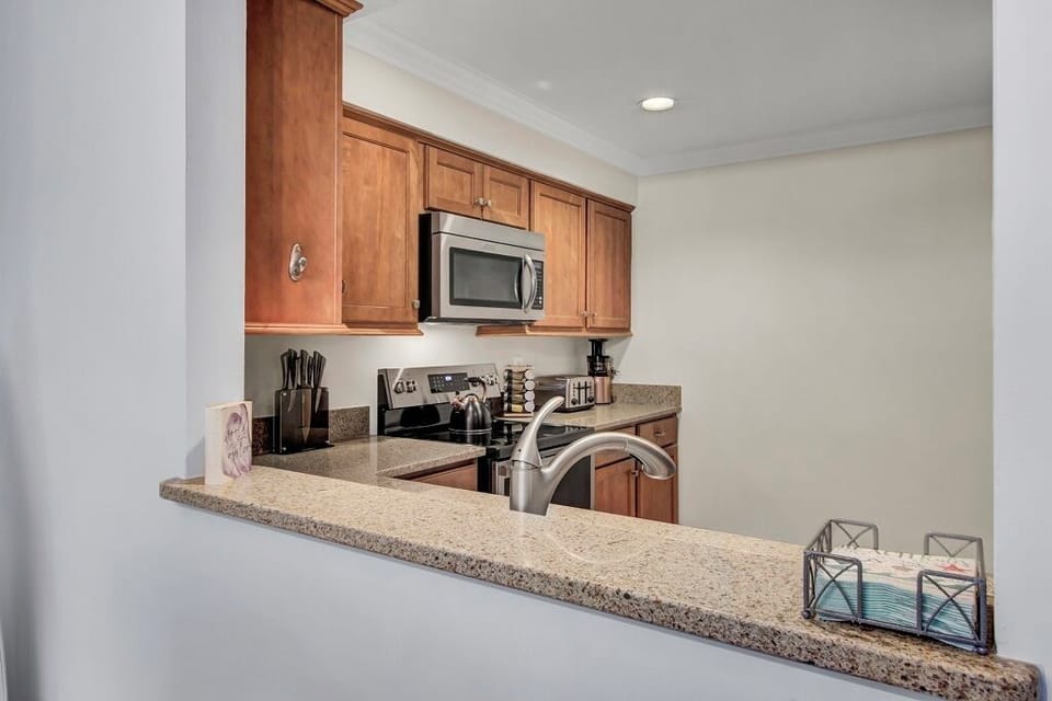 - Cook, sip, & socialize all in one space with this open concept kitchen - Stainless steel appliances, granite countertops, & everything you need at your fingertips - Perfect for whipping up pancakes or pouring a glass of wine while chatting with friends