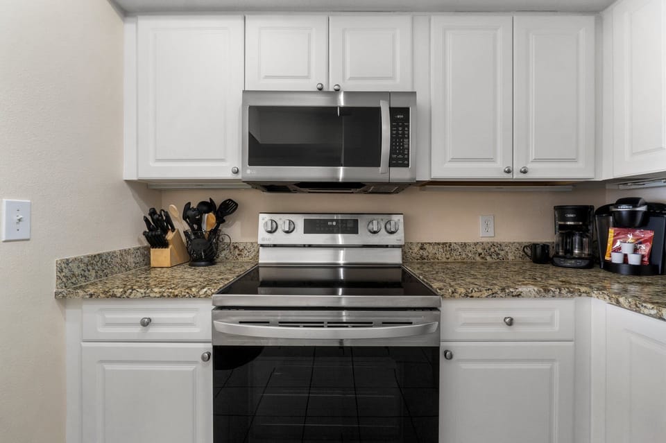 The fully equipped kitchen features granite countertops, stainless-steel appliances, and everything you need to cook meals for family and friends.