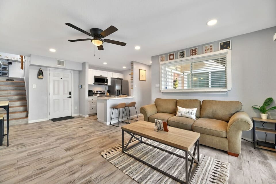 View of living room adjacent to dining and kitchen areas