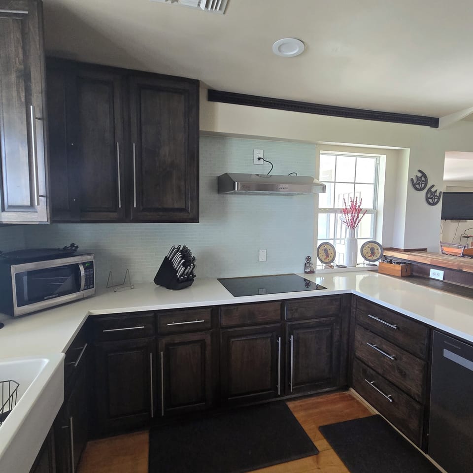 cook top, microwave, and fully stocked kitchen for preparing meals 