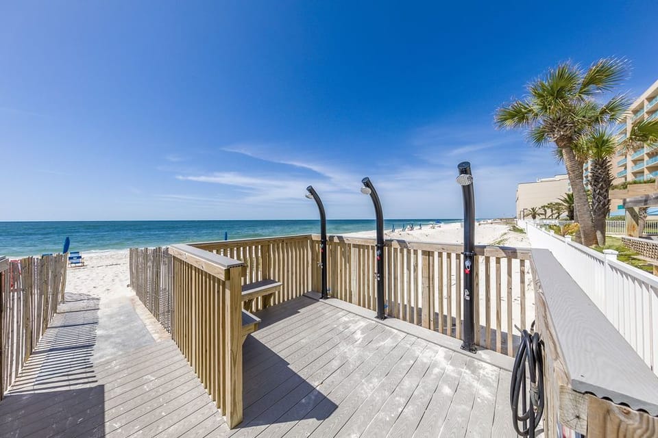 Step onto the beach walkway with convenient outdoor showers and soak in the stunning beachfront views