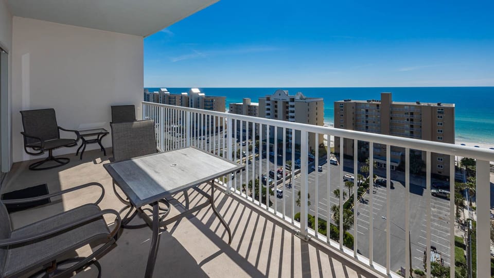 This balcony offers a stunning beach view with comfortable seating, perfect for relaxing and enjoying the scenery