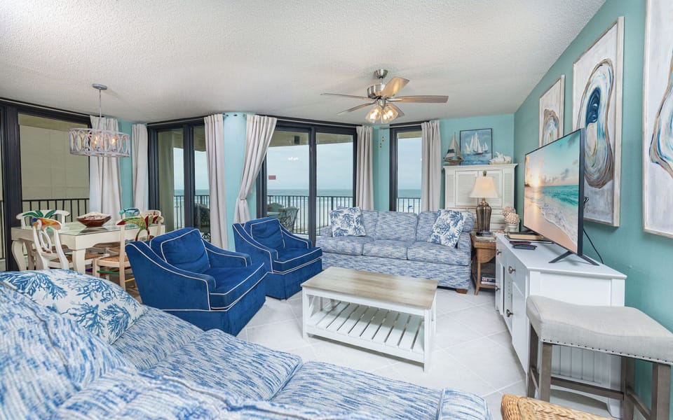 Two plush blue chairs in the living room invite you to relax and watch your favorite show on the TV