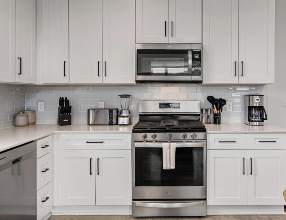 Bright, fully stocked kitchen with stainless appliances, plenty of counter space, and all the essentials for cooking at home.
