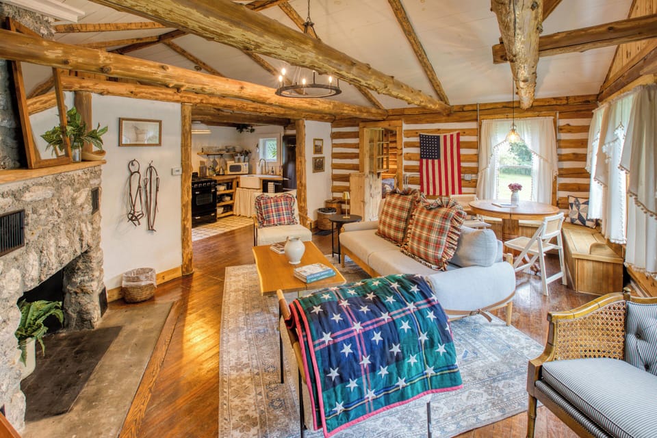 Relax in our cozy living room, decorated with rustic Americana charm and a warm stone fireplace. (2)