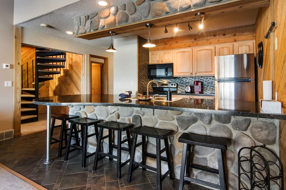 Roomy Kitchen with Six Barstools for Eating. 