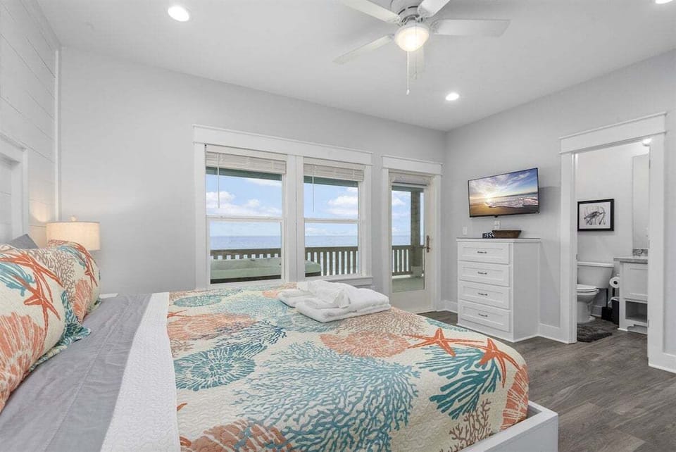 Bedroom with beach-themed décor and water views in Bolivar Peninsula oceanfront vacation home