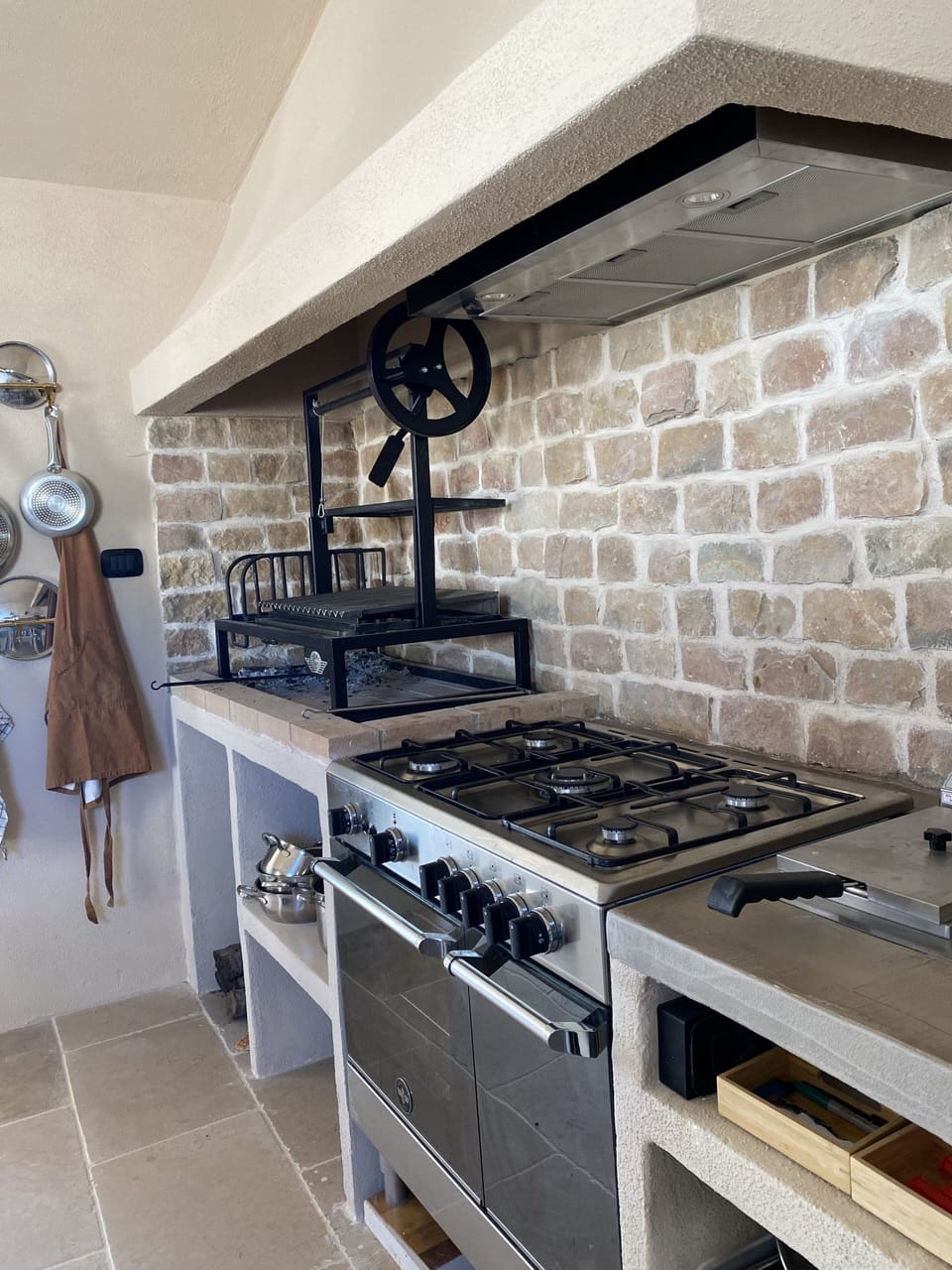 Inside open fire place and a Bertazzoni stove and oven