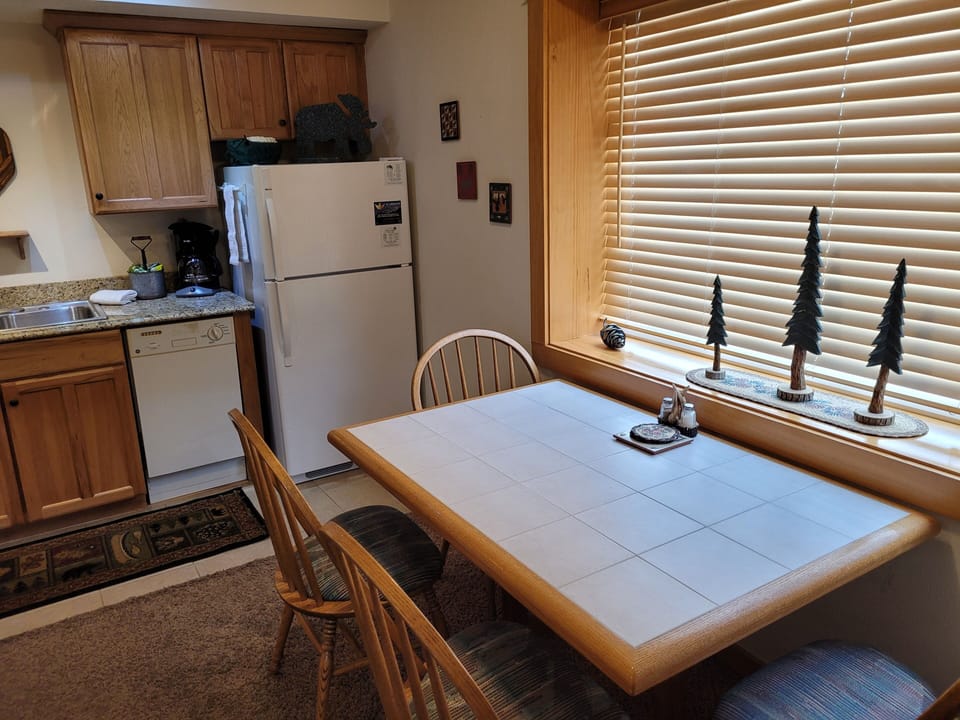 Dining table next to kitchen, seats 4