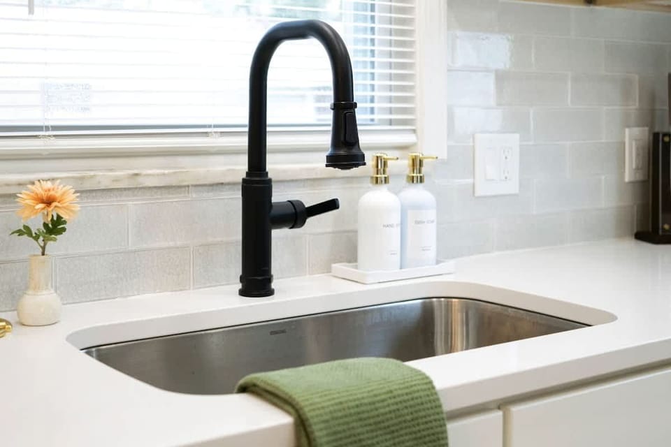 Close-up of sink area w/ sleek faucet & clean countertop design