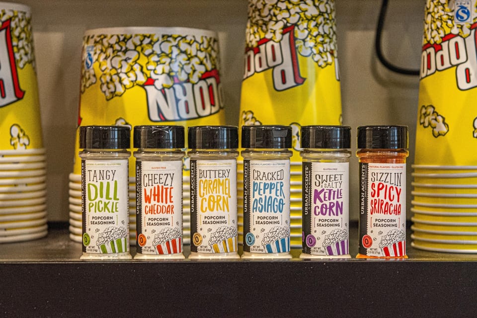 We provide popcorn kernels and six seasoning flavors — from buttery caramel to spicy sriracha — for the vintage popcorn machine. Movie night essentials are covered.