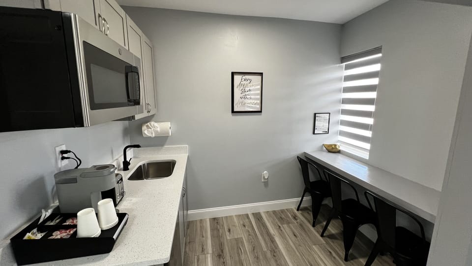 Kitchenette is equipped with mini fridge, microwave, toaster, coffee machine