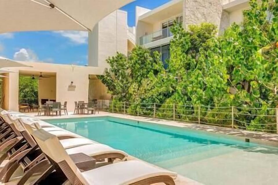 Escape to serene vacation bliss at our lavish pool oasis. Unwind under umbrellas in stylish loungers