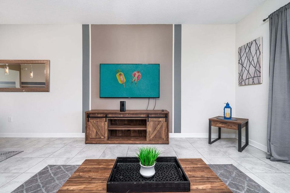 Cozy living room with a TV and plush, comfortable seating.