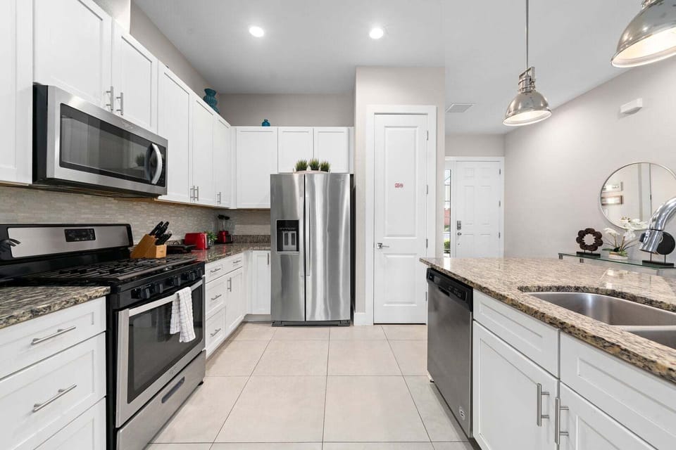 Cook with ease in a kitchen featuring stainless steel appliances and all essentials.