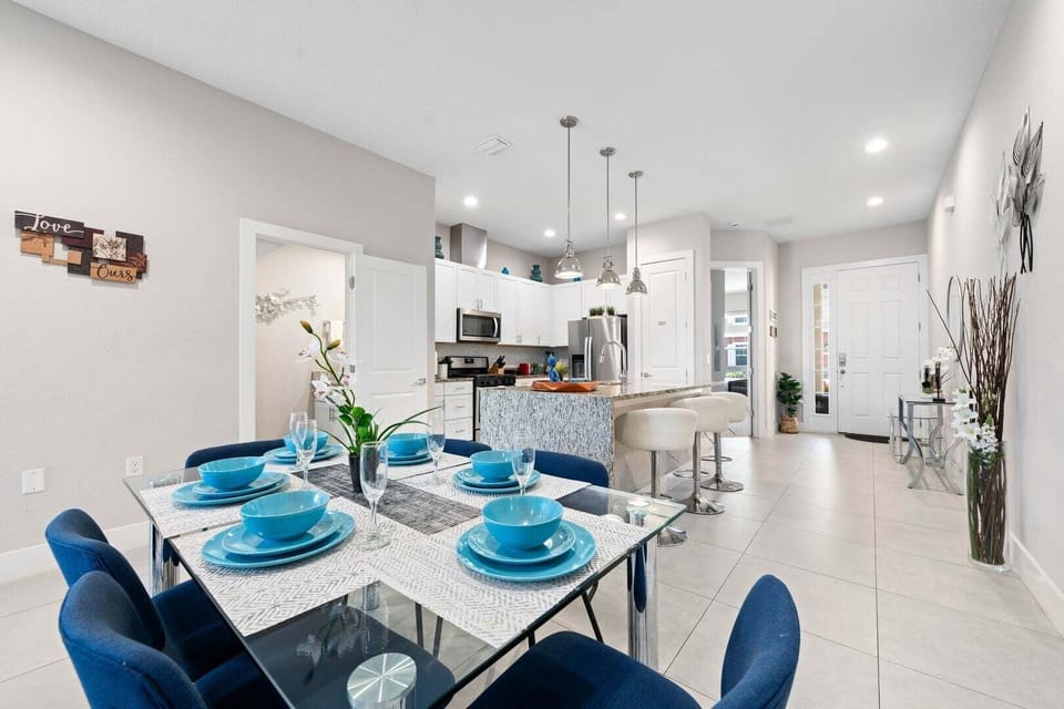 Featuring an open-concept layout that seamlessly connects the dining area, living room, and kitchen, for a practical and inviting space for gatherings.