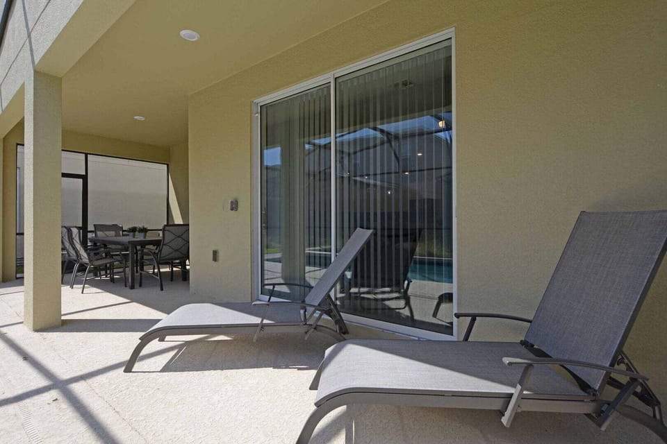 The private pool features lounge chairs, perfect for unwinding after a long day at the parks.