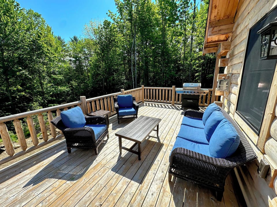 Deck with dining table, seating area, and grill